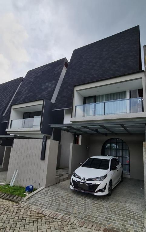 a white car parked in front of a house at Vincaza villa in Tlekung