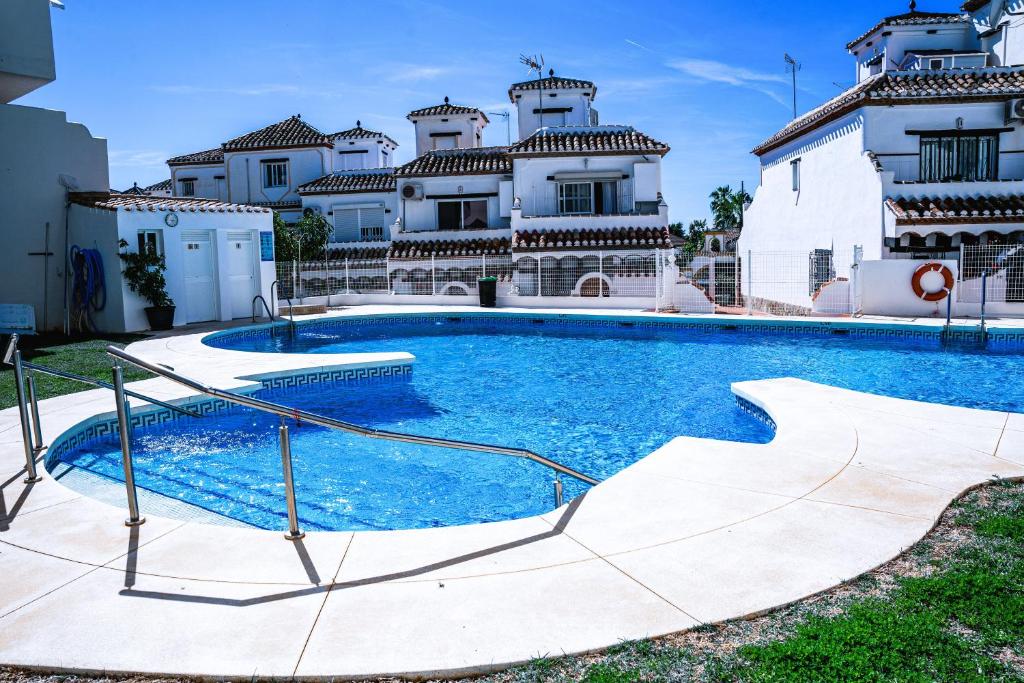 a large swimming pool in front of a house at Casa Costa del Sol Beach&Golf,Marbella in Sitio de Calahonda