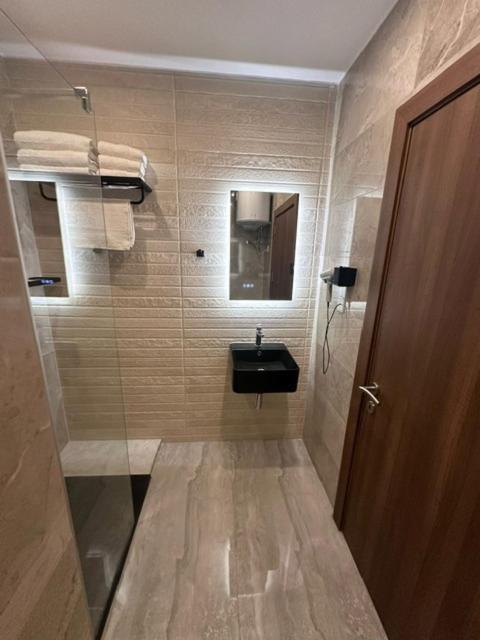 a small bathroom with a sink and a mirror at La Bella Guesthouse in St. Julianʼs