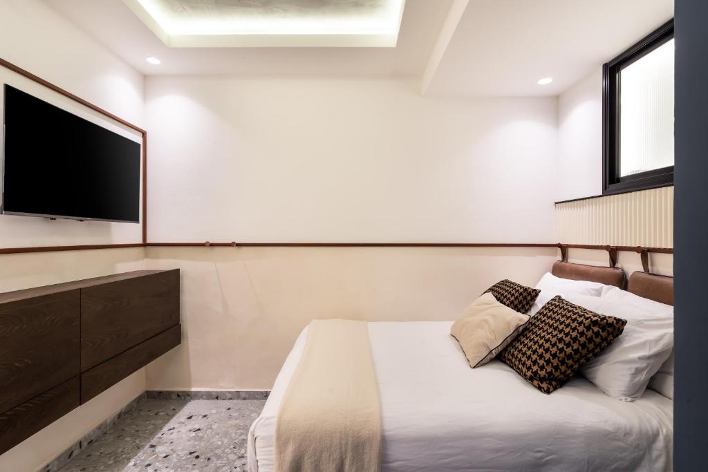 Postel nebo postele na pokoji v ubytování Mulan Hotel