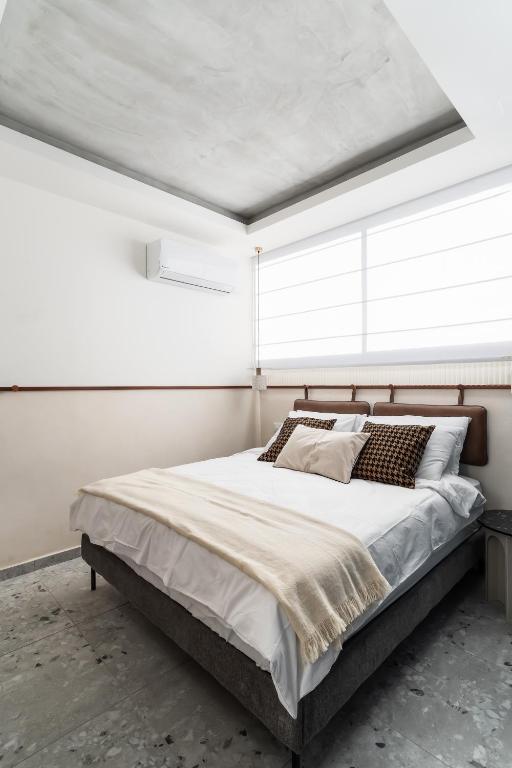 Postel nebo postele na pokoji v ubytování Mulan Hotel