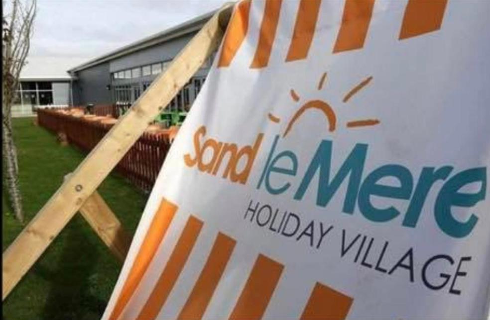 a sign for a sand entrance holiday village at Caravan Holidays at Sand le mere in Tunstall