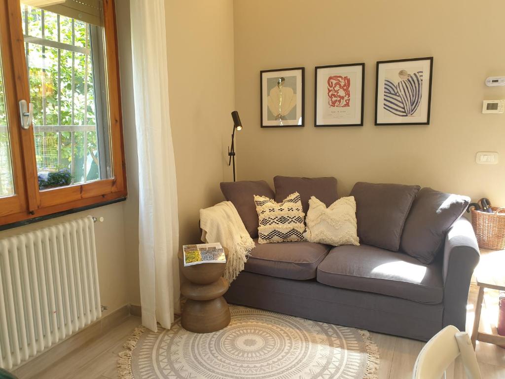 a living room with a couch and a window at Marty&Olly Luxury Garden Apt in Monterosso al Mare