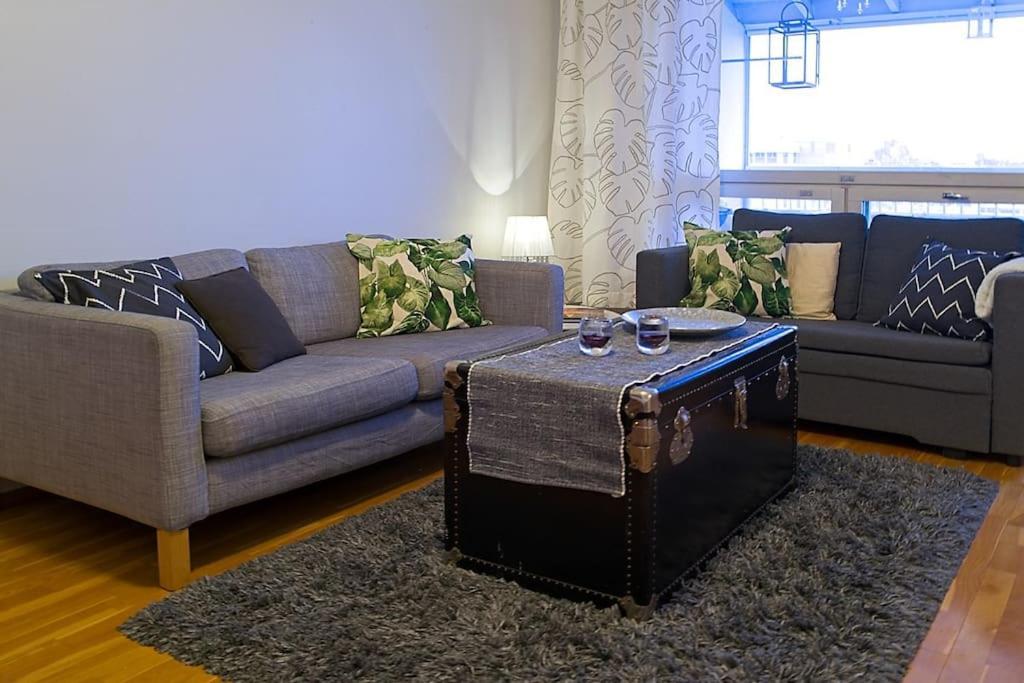 a living room with a couch and a coffee table at Top floor in central Leppävaara in Espoo
