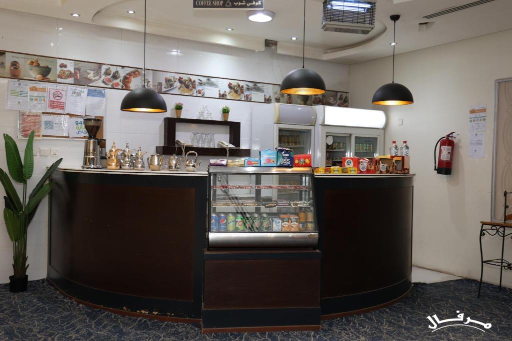 een restaurant met een bar met eten erin bij Merfal Serviced Apartments Royal in Riyad