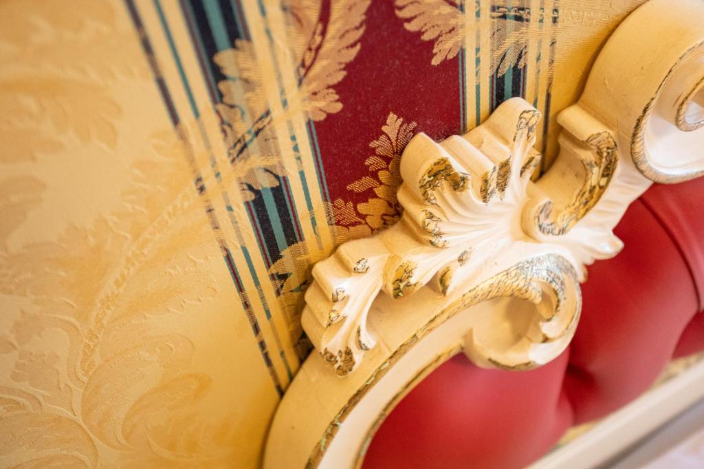 a close up of a gold dragon on a wall at Duomo Boutique Hotel in Chioggia