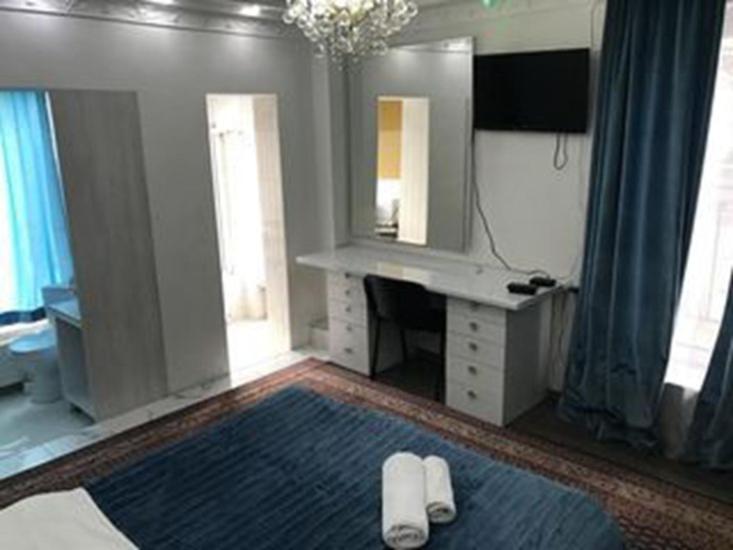a bathroom with a vanity and a sink and a mirror at Apartment 31 August in Chişinău