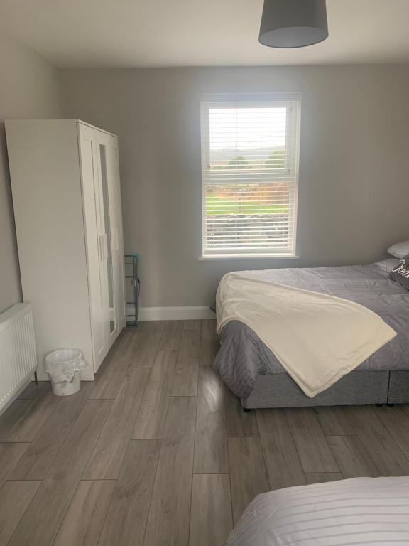 a bedroom with two beds and a window at Kilmoon Cottage, Entire home in Lisdoonvarna in Lisdoonvarna