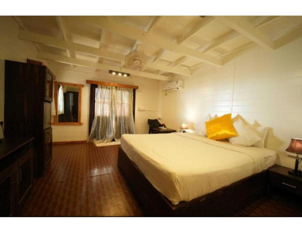 a bedroom with a large white bed in a room at Anantra Sea View Resort, Agonda, Goa in Agonda