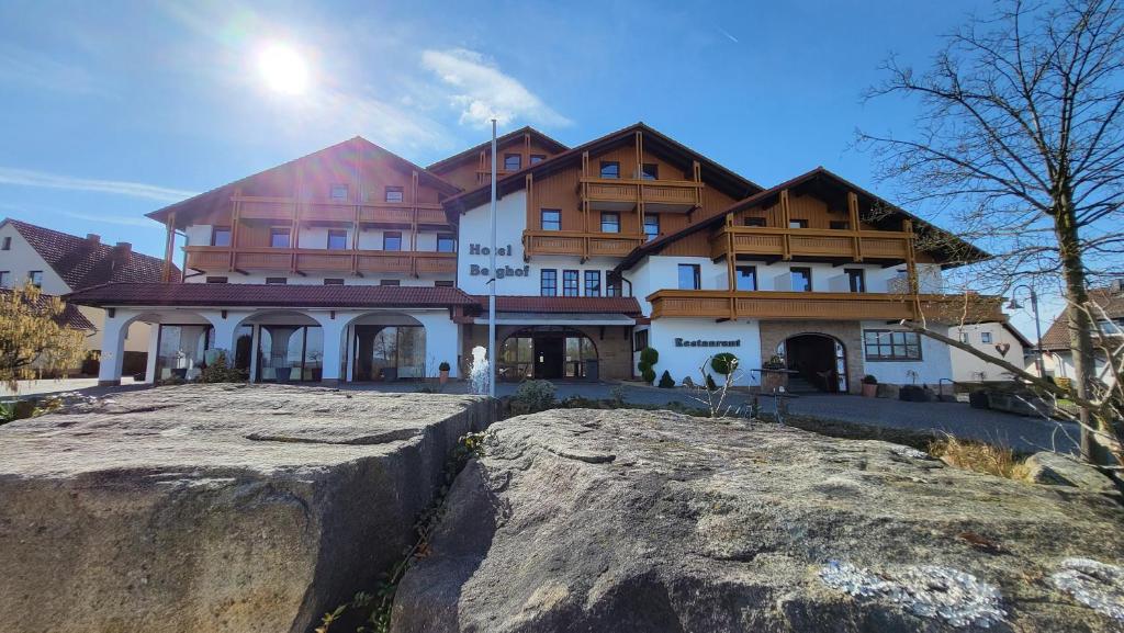 a large building on top of a large rock at Hotel Berghof in Petersberg