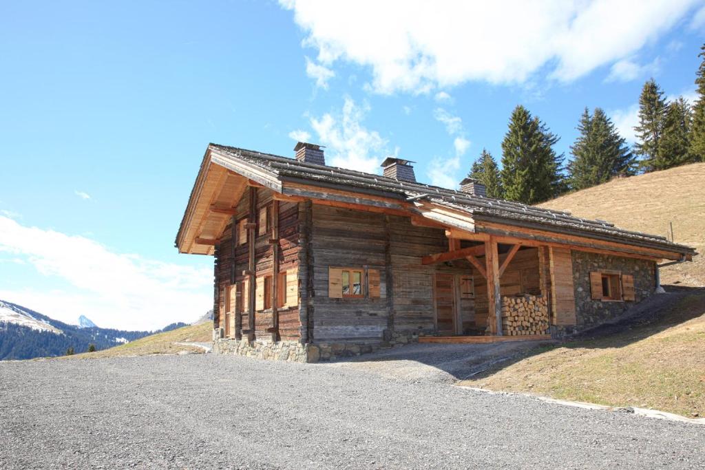 a log cabin on the side of a mountain at Chalet La Trafolée in Manigod