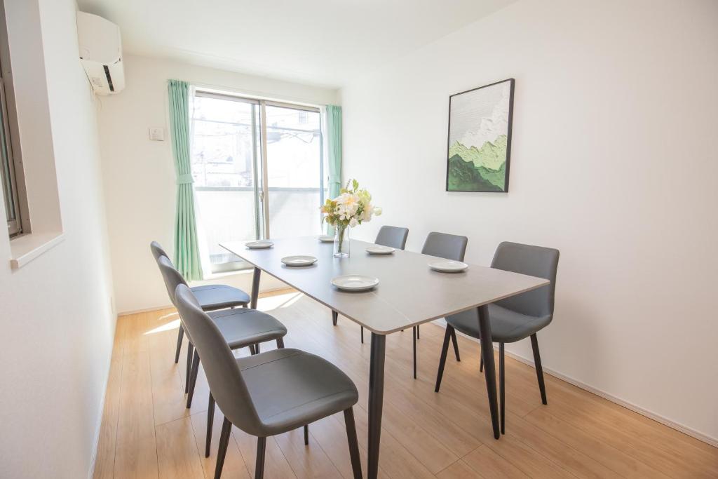 a dining room with a table and chairs at Comfort Walk to Takadanobaba Sta. - 3LDK SoYi / Dual Bathrooms & Washrooms for Families & Groups in Tokyo