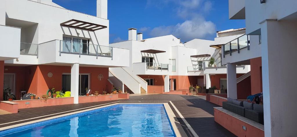 a swimming pool in front of a building at Casa Sienna, Burgau in Burgau
