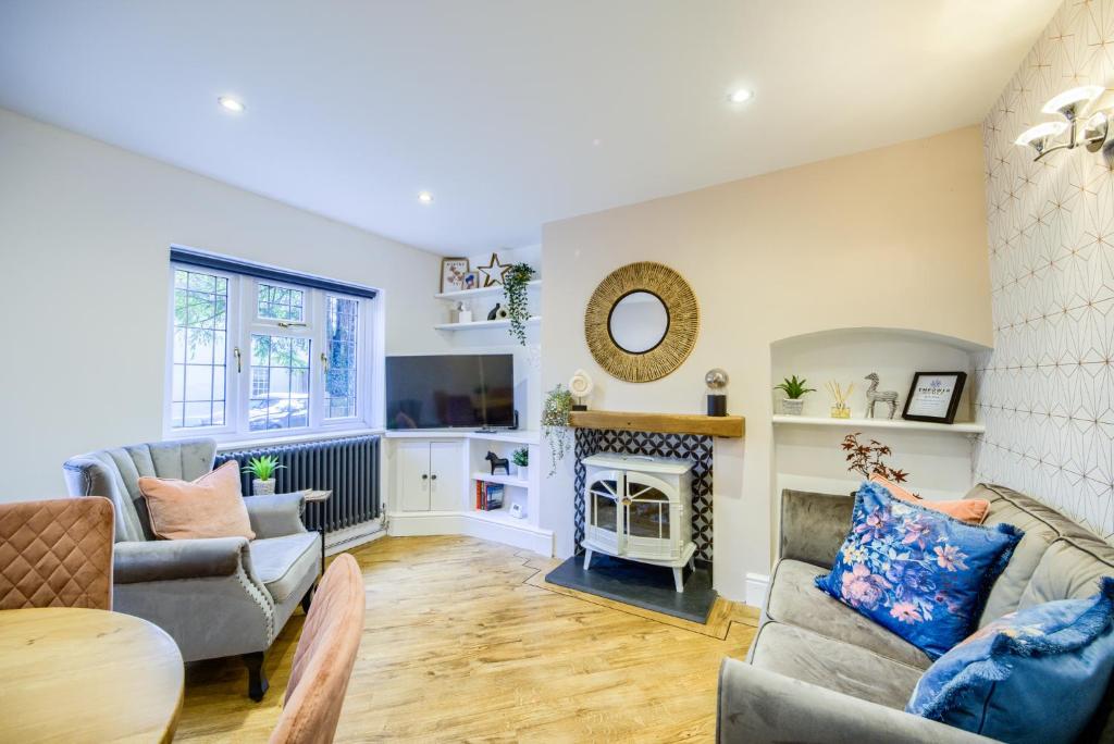 a living room with a couch and a fireplace at Warwickshire Beautiful Cottage, 2 dbl bed Sleeps 4 by EMPOWER HOMES in Kenilworth