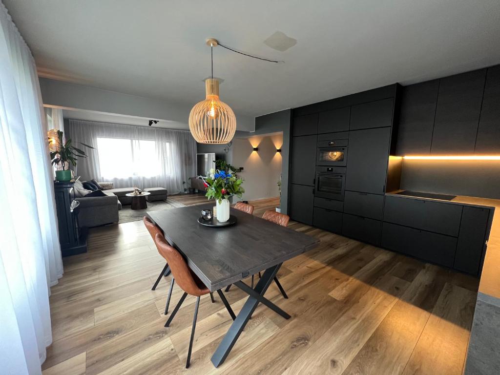 a kitchen and living room with a dining room table at B17 Apartment in Njarðvík