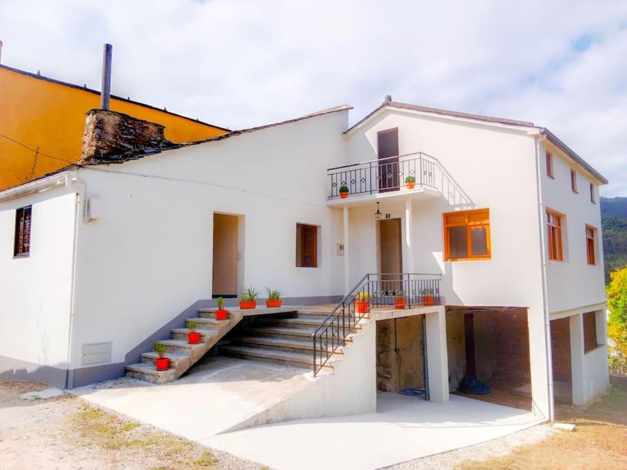 a white house with stairs in front of it at Casa Calvo in Vivero