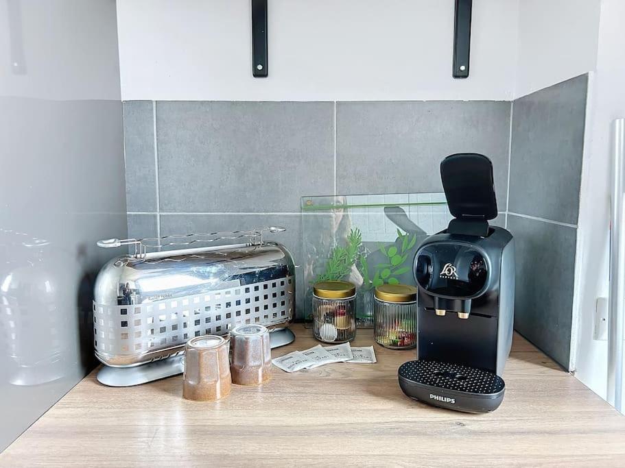 a kitchen counter top with a toaster and a toaster at Le Raphaëlle - Compiègne centre in Compiègne