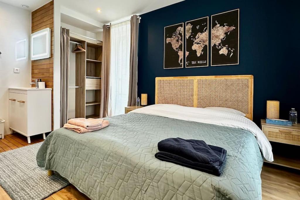 1 dormitorio con 1 cama grande y pared azul en Airbnb à Paris-Bois de Vincennes en Saint-Maurice