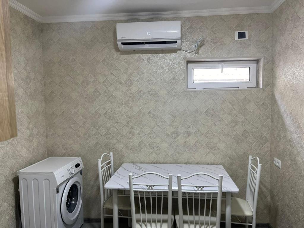 eine Waschküche mit einem Tisch und einer Waschmaschine in der Unterkunft Guest House in Tbilisi in Tbilisi City
