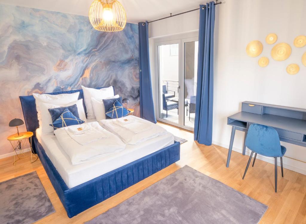 a bedroom with a large bed and a desk at River Lux Suite - 5 min to HBF in Wetzlar