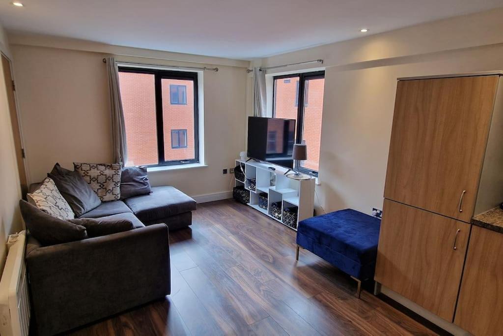 a living room with a couch and a tv at Two Bedroom Flat B1 Birmingham ( Parking ) in Birmingham