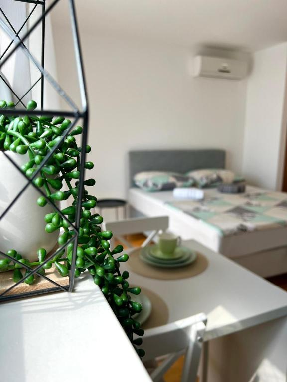 a room with a table with green spheres on it at Mostar in Mostar