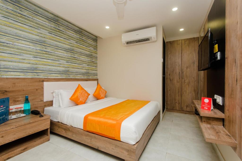 Habitación de hotel con cama y TV en OYO Hotel Blue Ocean Near R City Mall en Bombay