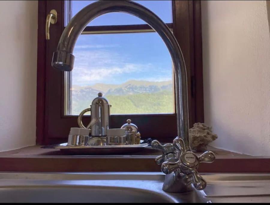 a kitchen sink with a faucet in front of a window at Casa Berton in Mochignano