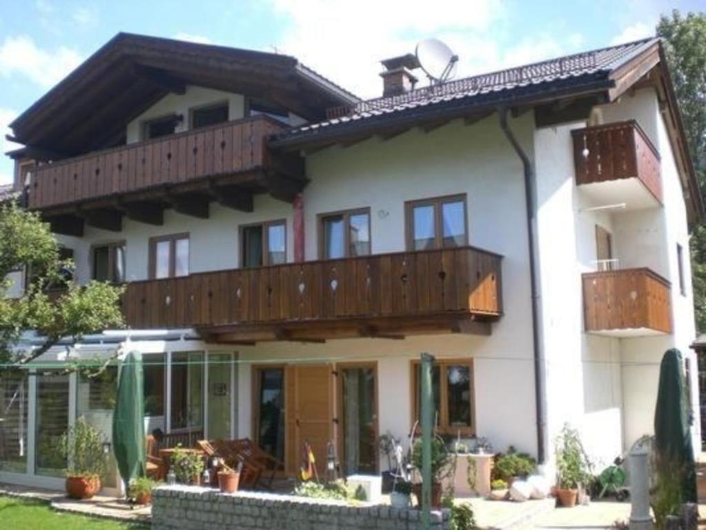 a large white house with a large balcony at Ferienwohnung in Garmisch-Partenkirchen - b48490 in Garmisch-Partenkirchen