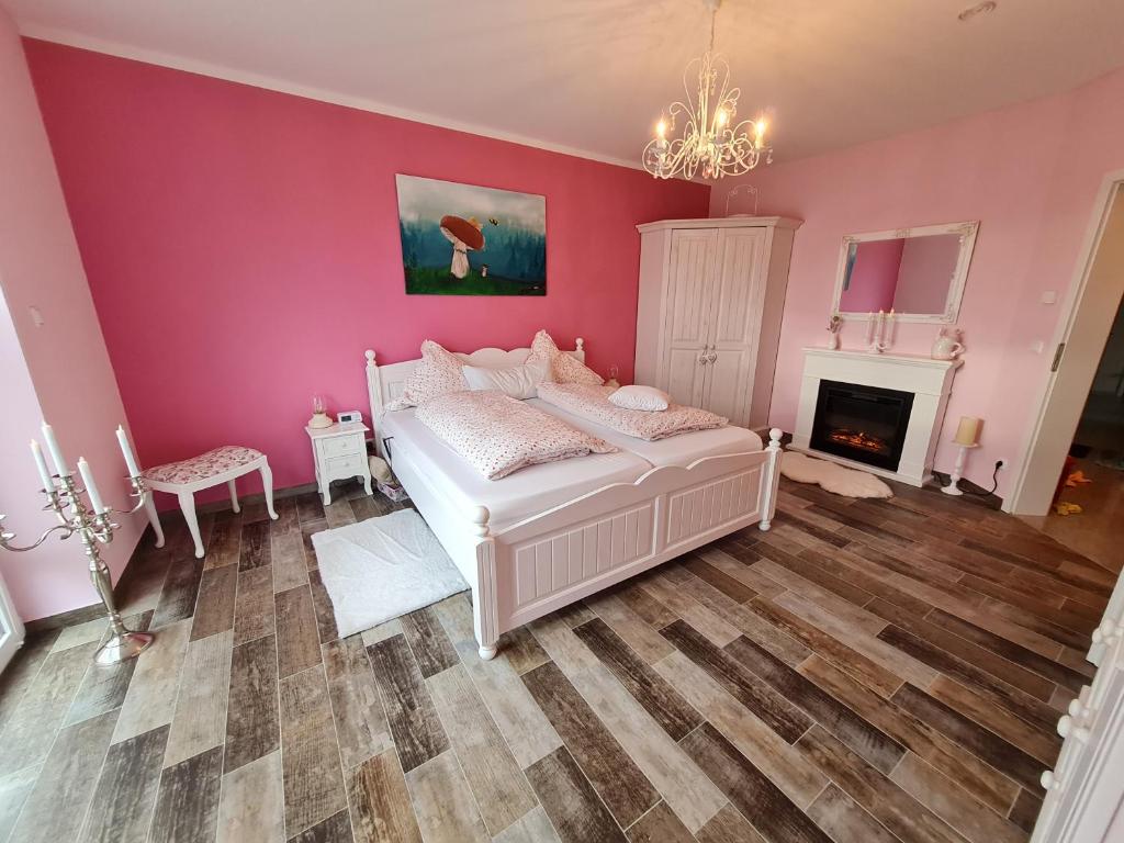 a bedroom with a white bed and a fireplace at Premium Apartment in Sehnde
