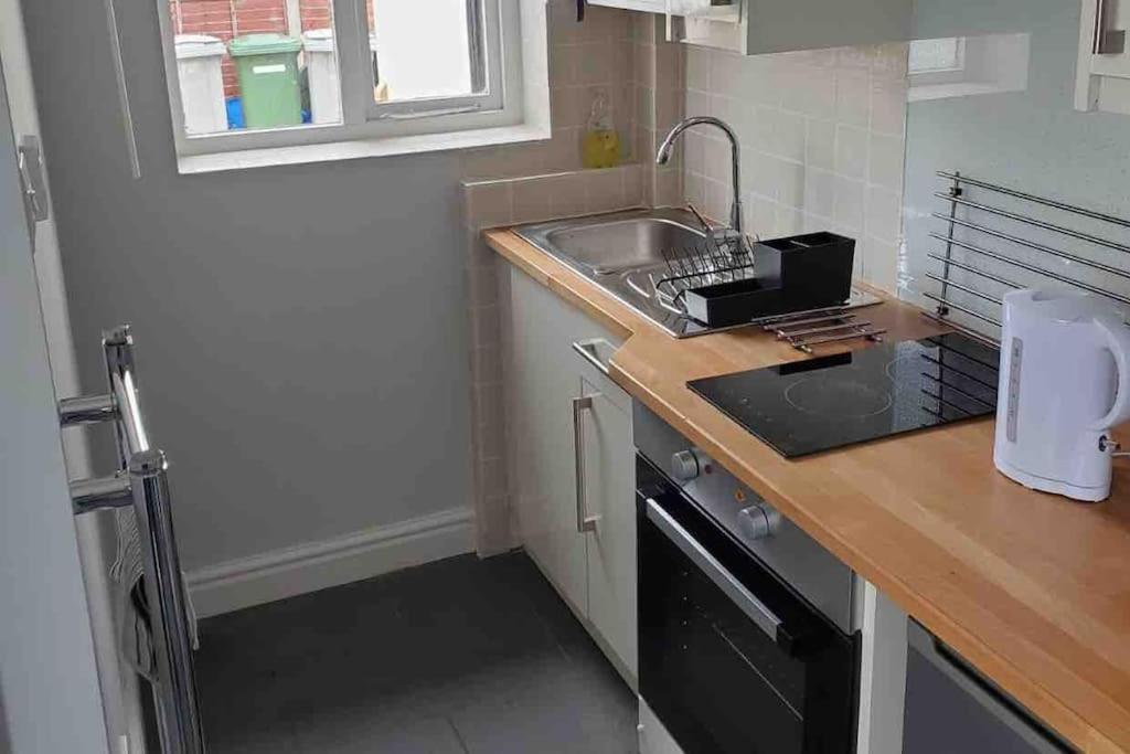 a small kitchen with a sink and a counter at Tiny one bedroom house in Mablethorpe