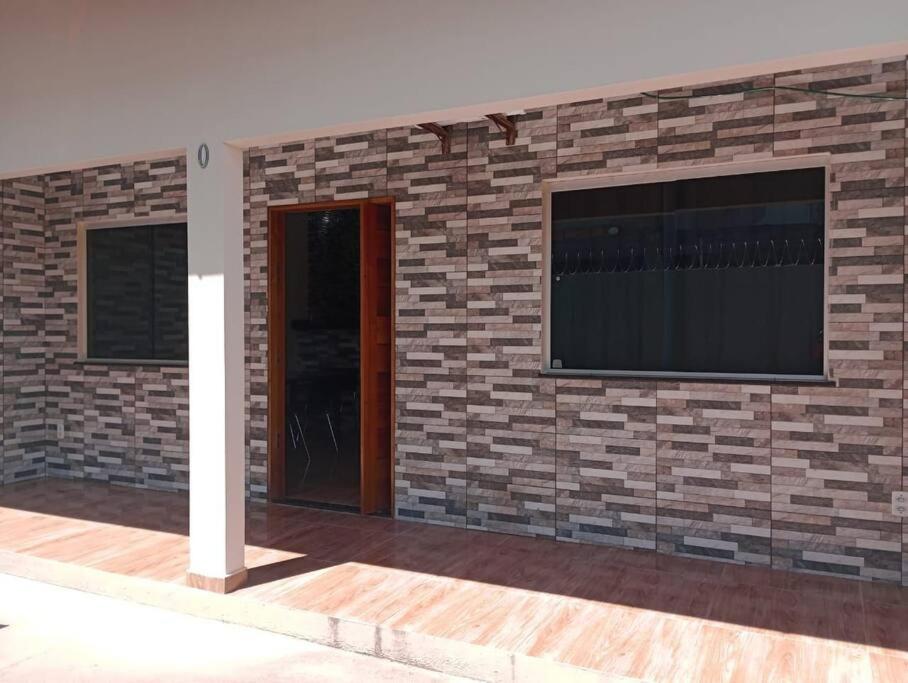 a brick wall with a television and a window at Apartamento Mobiliado aconchegante - Wi-Fi in Boa Vista