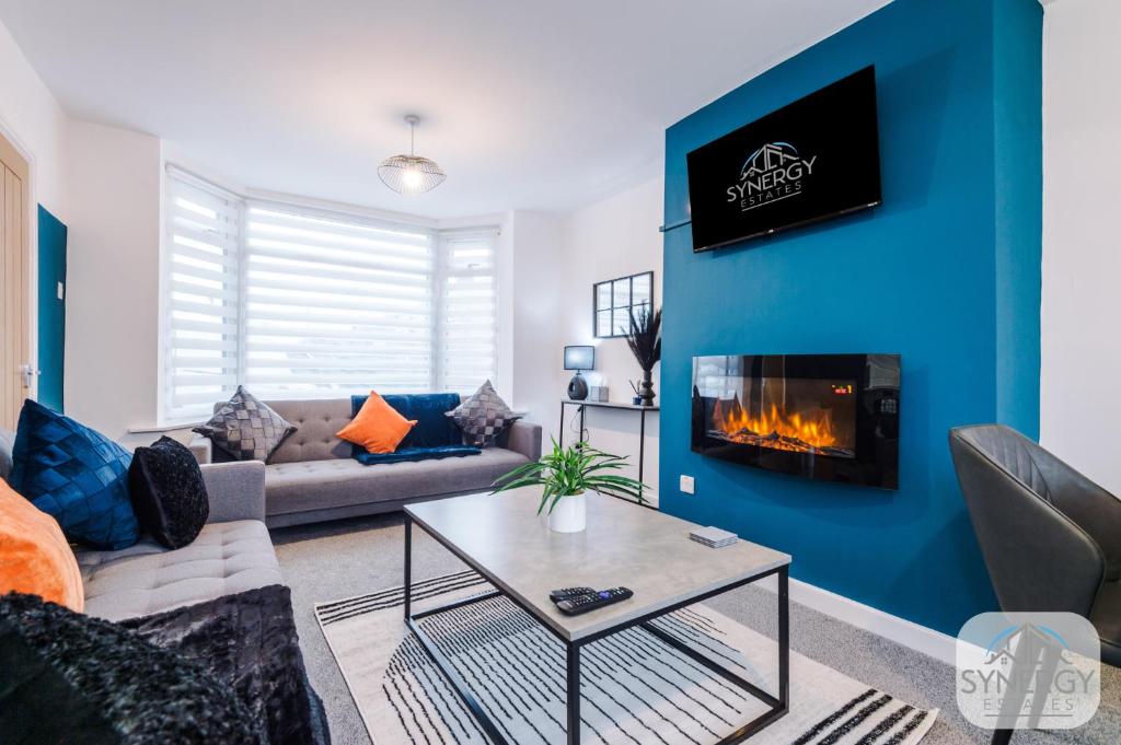 a living room with a couch and a fireplace at Pacific House, Manchester - by Synergy Estates in Manchester