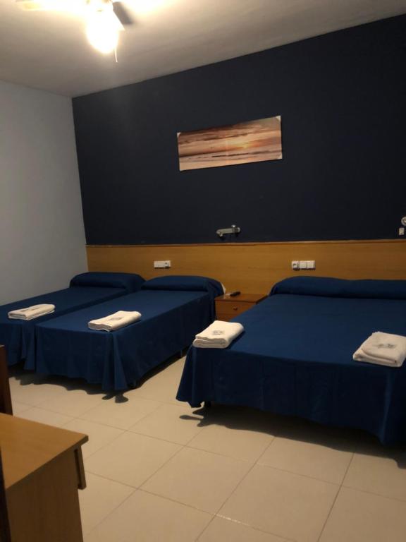 Postel nebo postele na pokoji v ubytování Hotel Sant Jordi