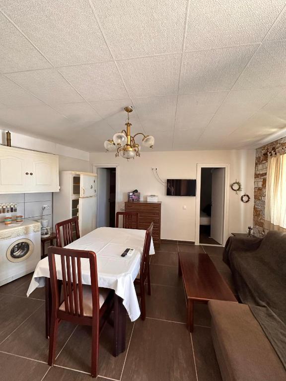 a kitchen and dining room with a table and chairs at πετρινη κατοικια in Vári