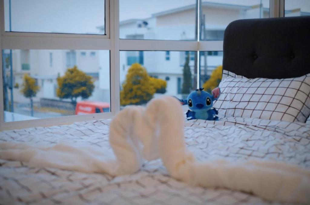 a bed with a stuffed animal on top of it at 16pax+Ninja's SweetHome Seremban in Seremban