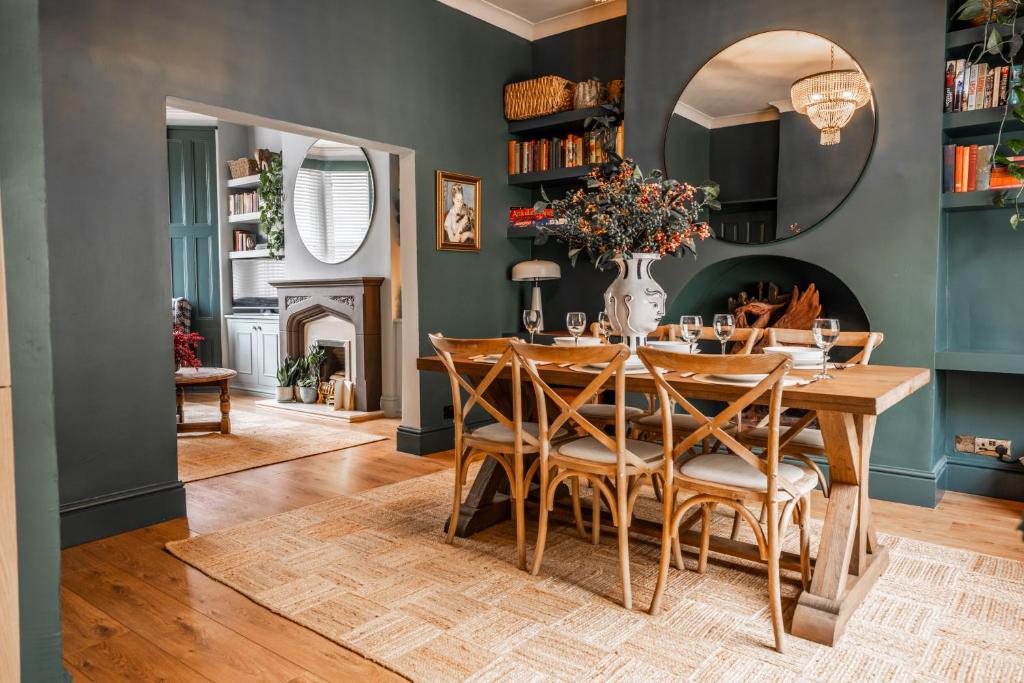 a dining room with a table and chairs at Arkles - Victorian Gem in Liverpool