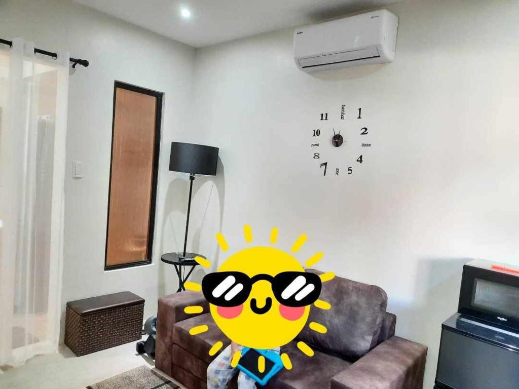a living room with a cartoon sun on the wall at Casa G in Manila