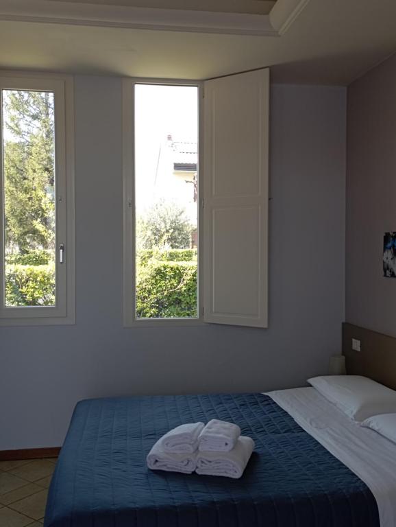 Postel nebo postele na pokoji v ubytování Camere Girasole