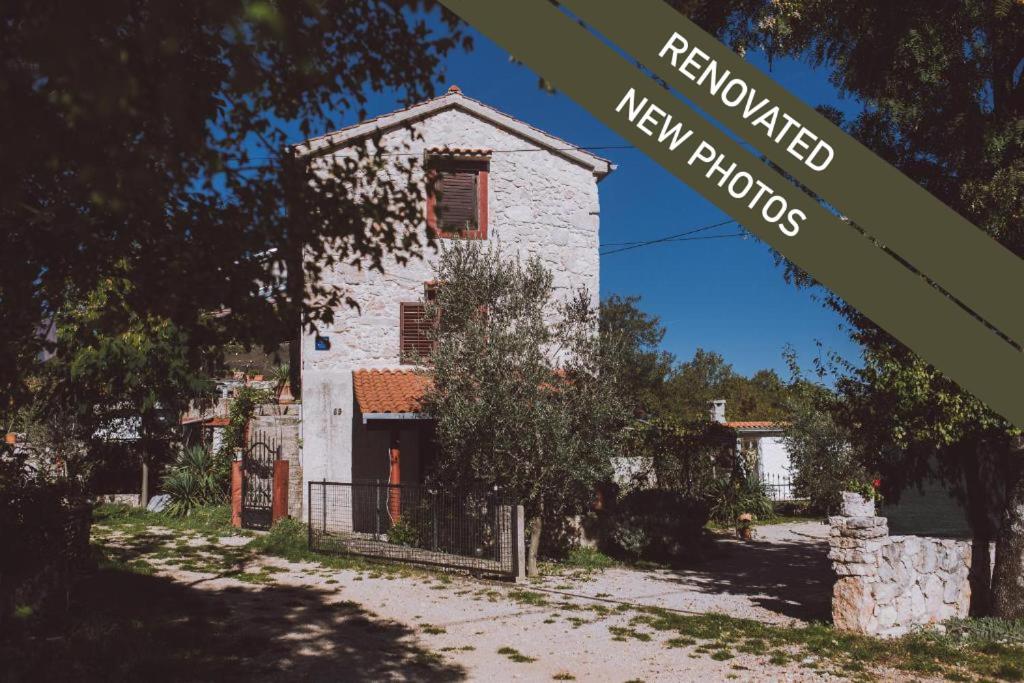 a building with a sign that reads renovated new homes at Cosy Getaway in Gostinjac