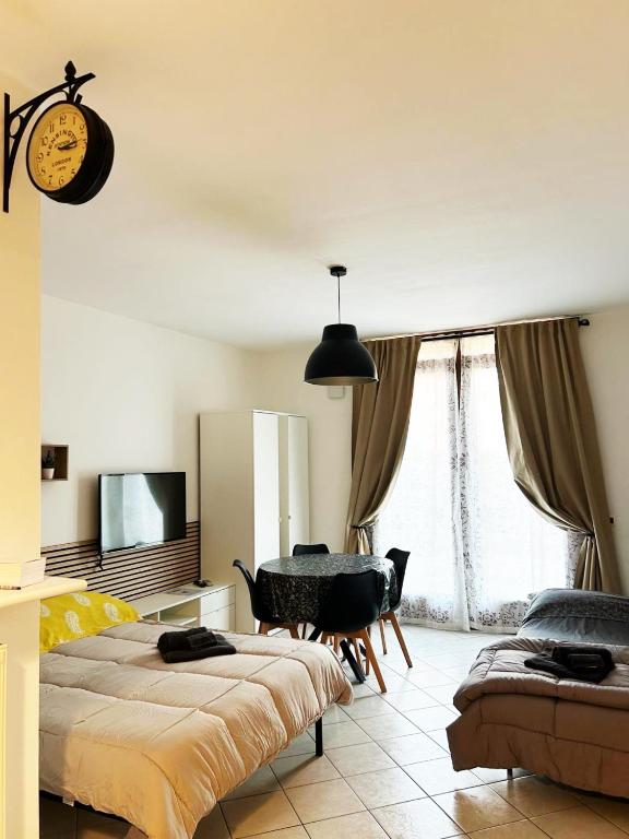 a bedroom with two beds and a table and a television at Jeemma in Galliera Veneta