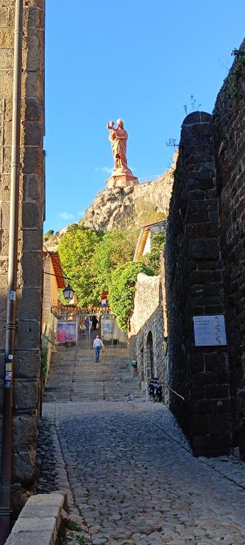 a stone street with a tower on top of a hill at La ch&#39;tiote meizou in Mazet-Saint-Voy