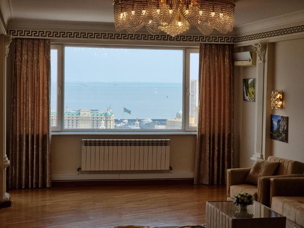 a living room with a large window at Central sea view in Baku