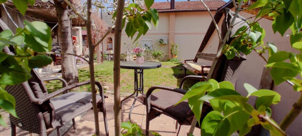 a patio with chairs and a table in a yard at Guest House Lejla in Travnik