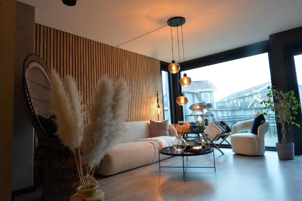 a living room with a couch and a table at Private room in Hundvåg in Stavanger