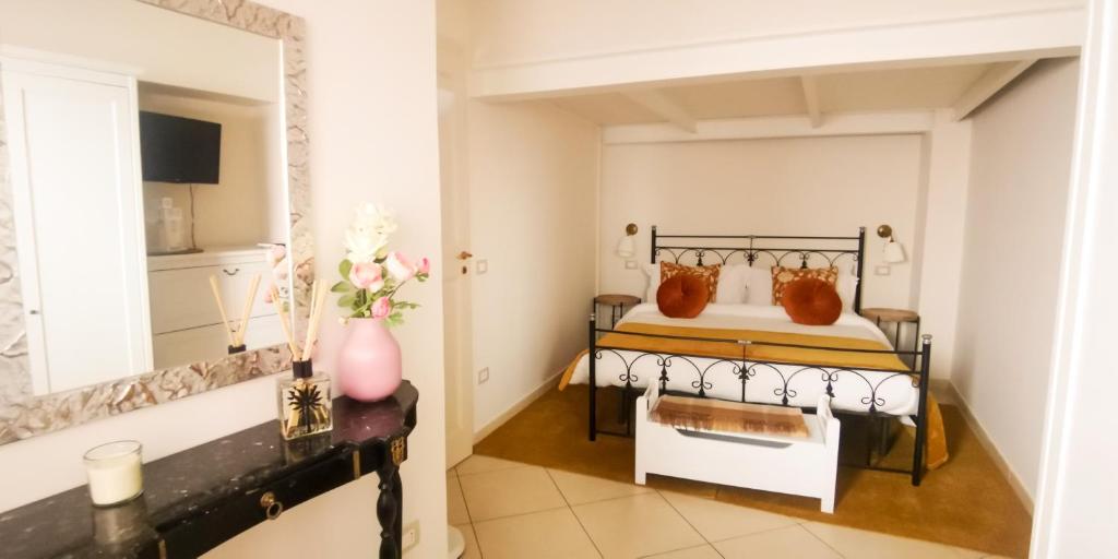 a bedroom with a bed and a mirror at Donna Rosa - Main Avenue in Taormina