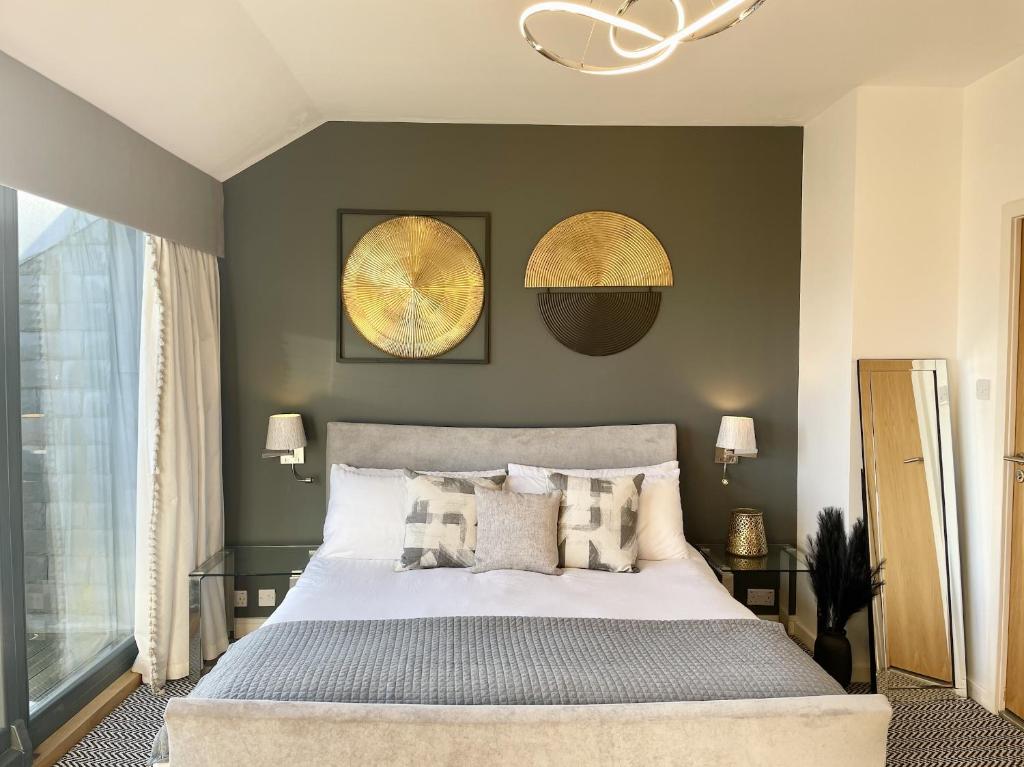 a bedroom with a large bed and two posters on the wall at Edinburgh Penthouse 101 in Edinburgh