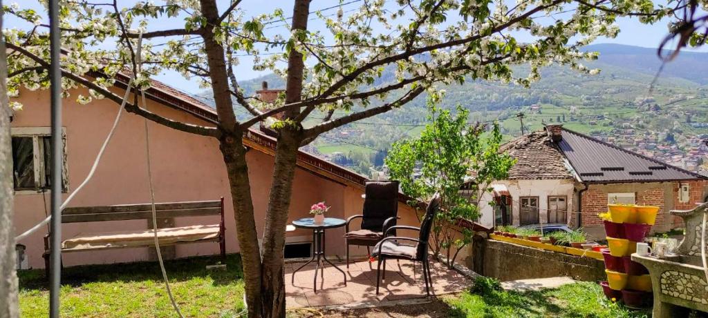 a small house with a table and chairs on a balcony at Guest House Lejla in Travnik