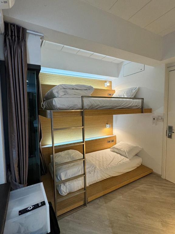 a room with three bunk beds in a room at One More Space in Chiang Mai