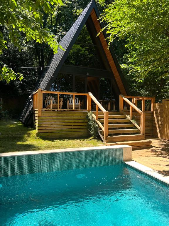 a house with a deck and a swimming pool at Chalet Sapanca in Sakarya
